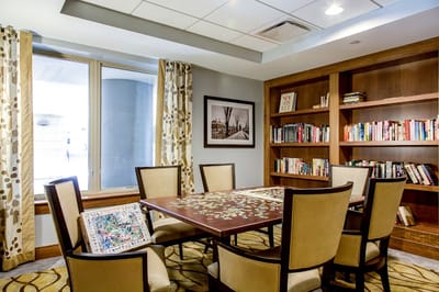 Common area with bookshelves and a puzzle table