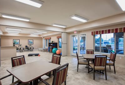 Bright common area with seating and exercise equipment.