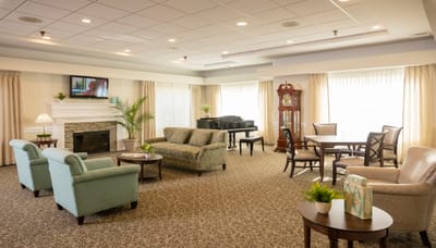 Bright common area with seating and piano