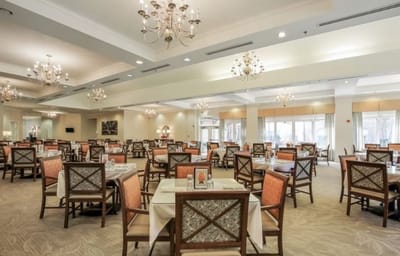 Elegant dining area with tables and chairs for residents