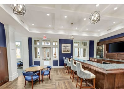 Interior view of a common area with seating and a bar.
