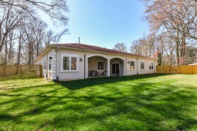 Outdoor view of a memory care facility with a grassy area