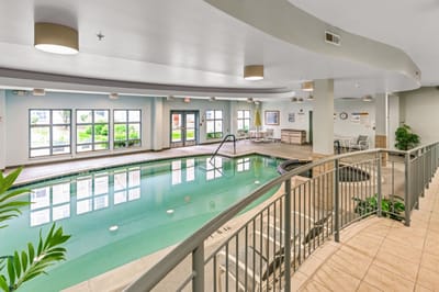 Indoor swimming pool area with seating