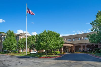 Exterior view of Town Village Tulsa with American flag