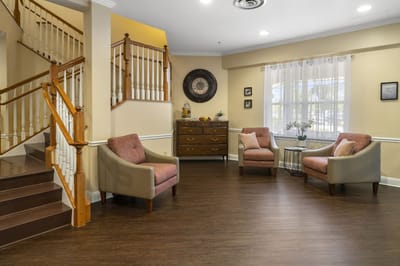 Cozy common area with armchairs and staircase