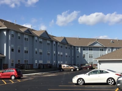 Exterior view of Tregaron Senior Apartments showing building and parking