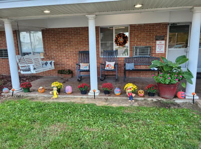 Decorated porch with seasonal plants and props