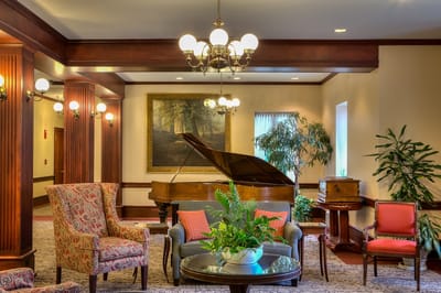 Interior view of a cozy common area with a piano