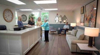 Staff assisting a resident in the reception area