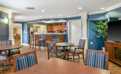 Bright common area with seating and kitchen bar