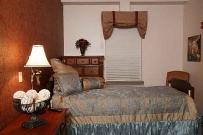 Cozy private bedroom with floral decor and warm lighting