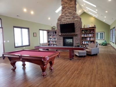 Common area with a pool table and bookshelves