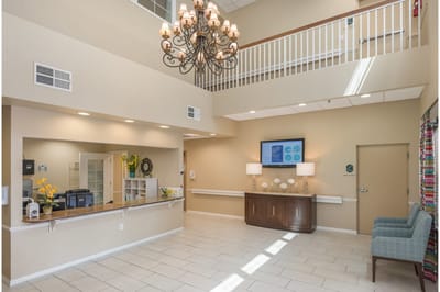 Bright interior of the lobby with a chandelier and seating.