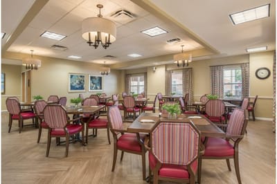 Bright dining room with tables and chairs for residents