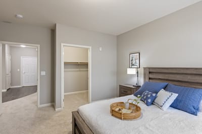 Well-decorated resident room with bed and nightstand