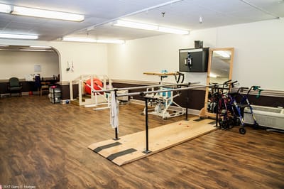 Rehabilitation room with exercise equipment and therapy bars