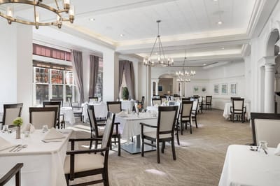 Elegant dining room with tables set for a meal
