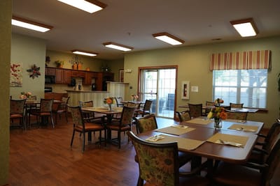 Bright dining room with tables and flowers