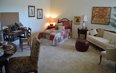 Cozy private resident room with bed and seating area