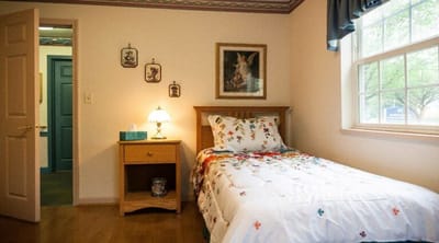 Cozy bedroom with floral bedding and lamp