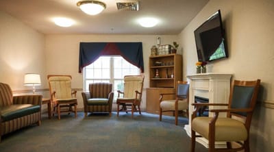 Common area with chairs and a fireplace