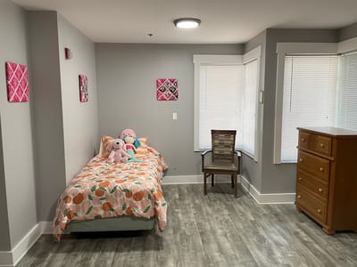 Cozy private room with light decor and plush toys