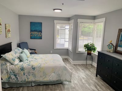 Bright private resident room with floral bedding