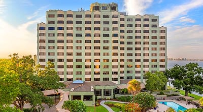 Exterior view of a senior living facility with gardens
