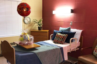 Brightly decorated resident room with a welcome balloon