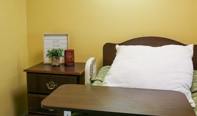 Cozy resident room with bedside table and decor