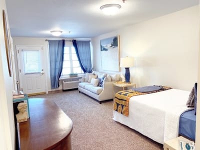 Cozy interior of a resident room with a sofa and bed