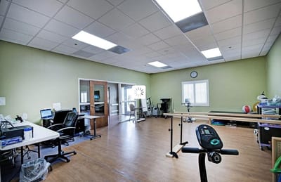 Interior view of a therapy room with exercise equipment