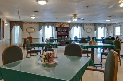 Bright common area with tables and chairs set up