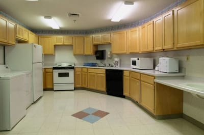 Kitchen area with wooden cabinets and appliances