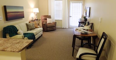 Cozy resident room with seating and a dining table