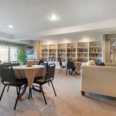 Interior view of a common area with tables and bookshelves
