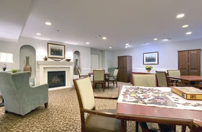 Common area with a fireplace and seating for residents