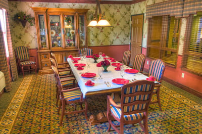 Dining room set for a meal with floral decor
