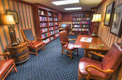 Cozy reading room with bookshelves and comfortable seating
