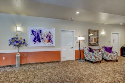Interior view of a cozy common area with decorative chairs