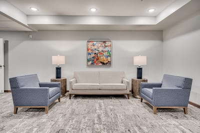 Cozy common area with comfortable seating and artwork