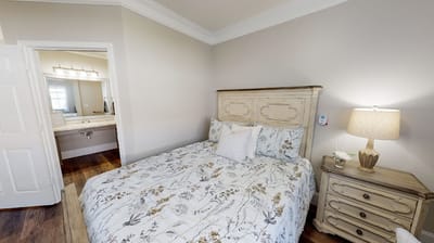 Cozy resident room with floral bedding and lamp