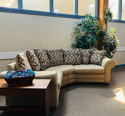 Cozy common area with a sectional couch and plants