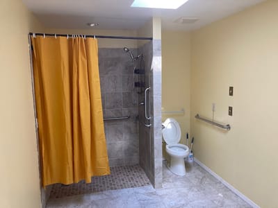 Accessible bathroom featuring grab bars and shower