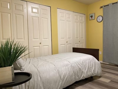 Private room with a bed and closet doors