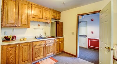 A kitchenette area within a senior living facility room