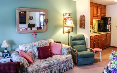 Cozy living area with floral couch and lamp