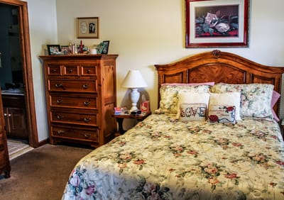 Cozy bedroom with floral bedding and wooden furniture