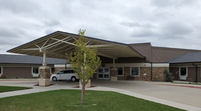 Front entrance of a senior living facility with covered area