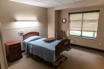 Private resident room with a bed and chair